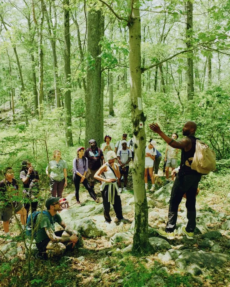 Group preparing camping gear at trailhead